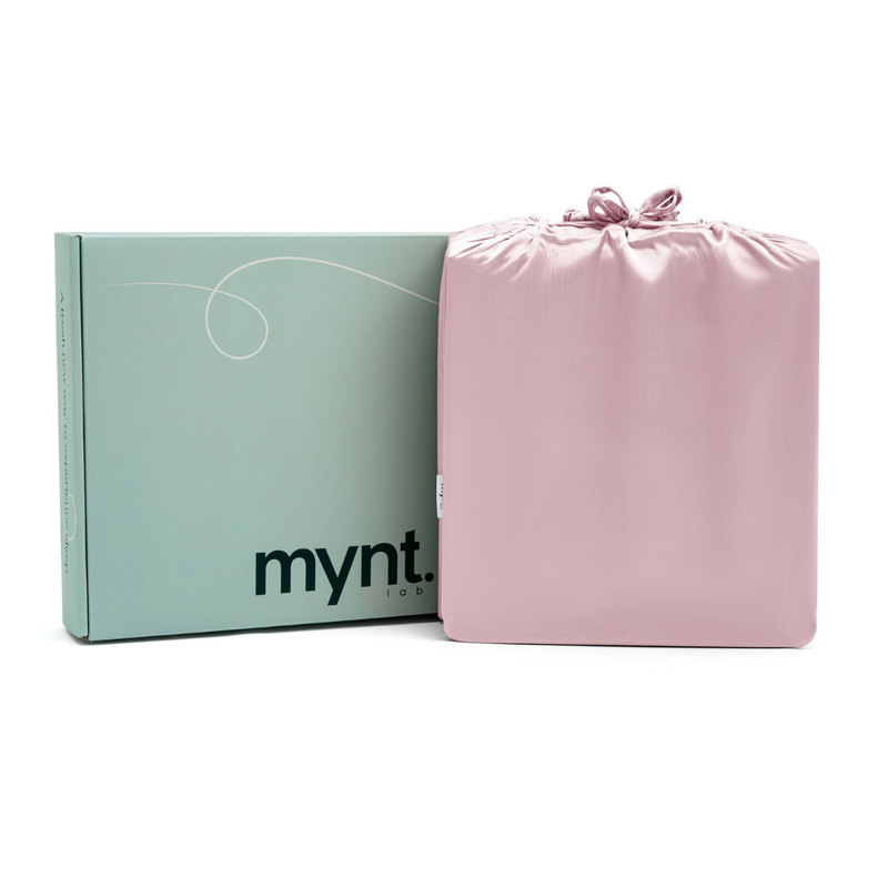 A light green mynt lab box sits beside a pink silky drawstring bag, both set against a white background - perfect packaging for the Pink Sheet Set.