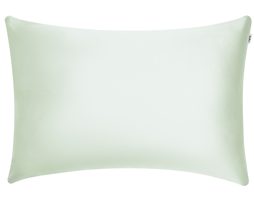 A plain, sage green silky pillowcase with a smooth texture, seen against a transparent background. The corners are rounded and there is a small fabric tag on the right edge.