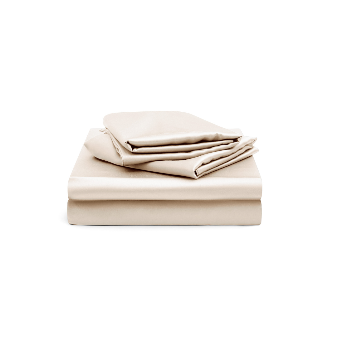 A neatly folded set of cream-colored bed sheets and pillowcases on a white background.