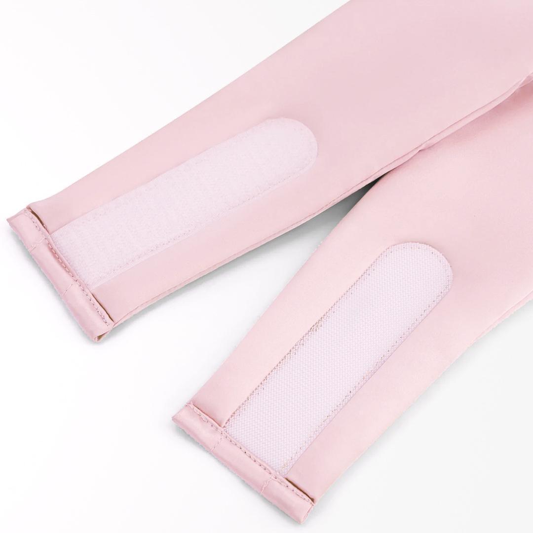 Close-up of two light pink Sleep Mask straps with white hook-and-loop fasteners, used to block light and support deep rest, shown against a plain white background.