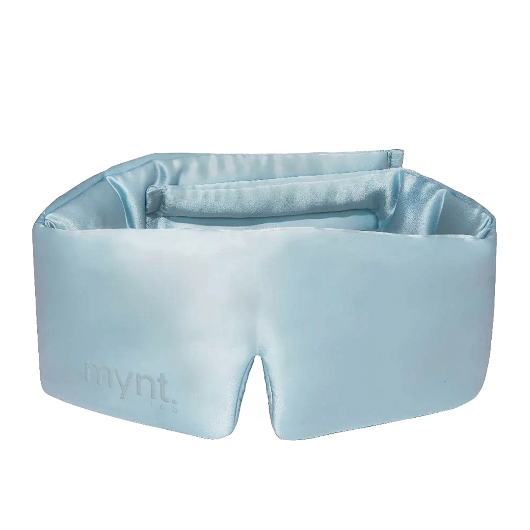 The Sleep Mask is a light blue silky eye mask featuring a soft, padded design and an embossed mynt lab logo, crafted for comfort and effective light blocking to support deep sleep.