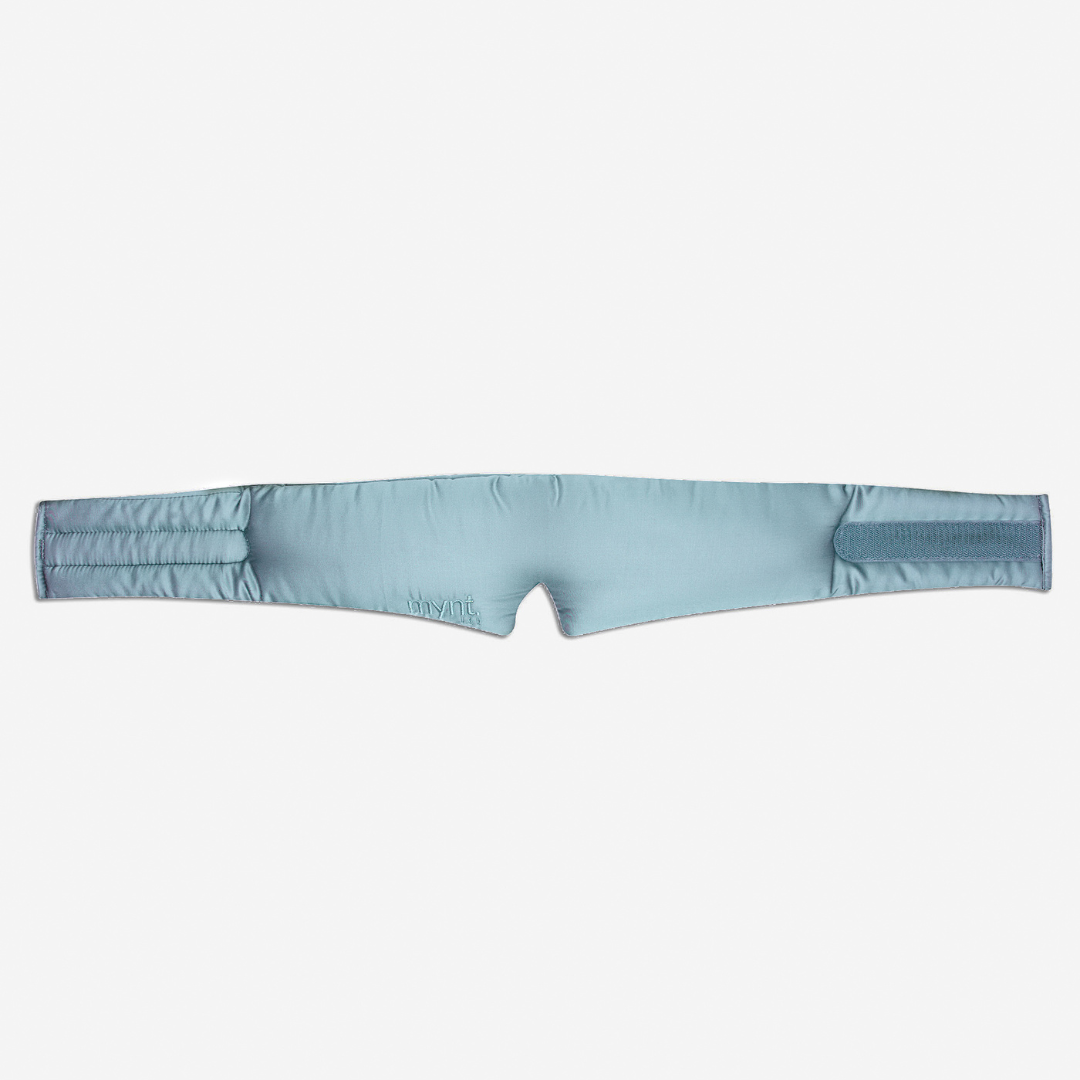 The Sleep Mask is light blue, padded, and contoured with a nose opening and Velcro closures at both ends - ideal for blocking light and promoting deep sleep.
