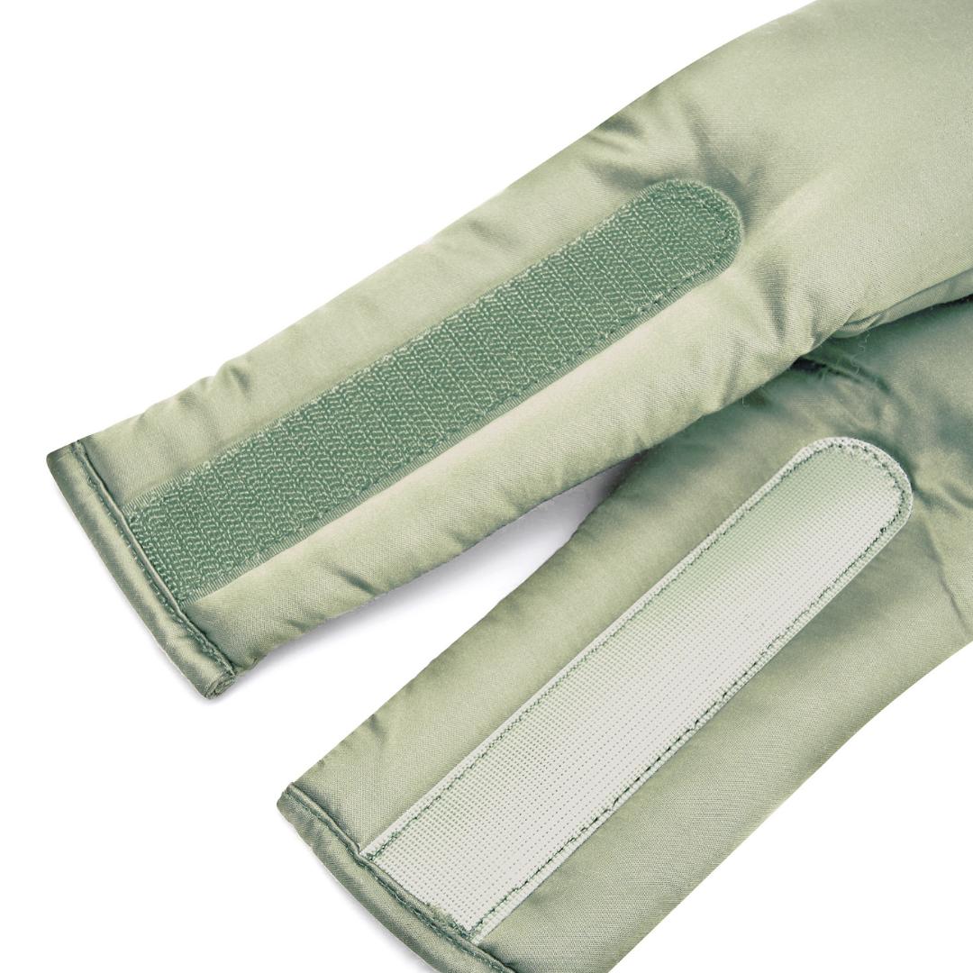 Close-up of two light green fabric straps with hook-and-loop fasteners, sewn onto padded material for the Sleep Mask - designed to block light, laying parallel on a white background.