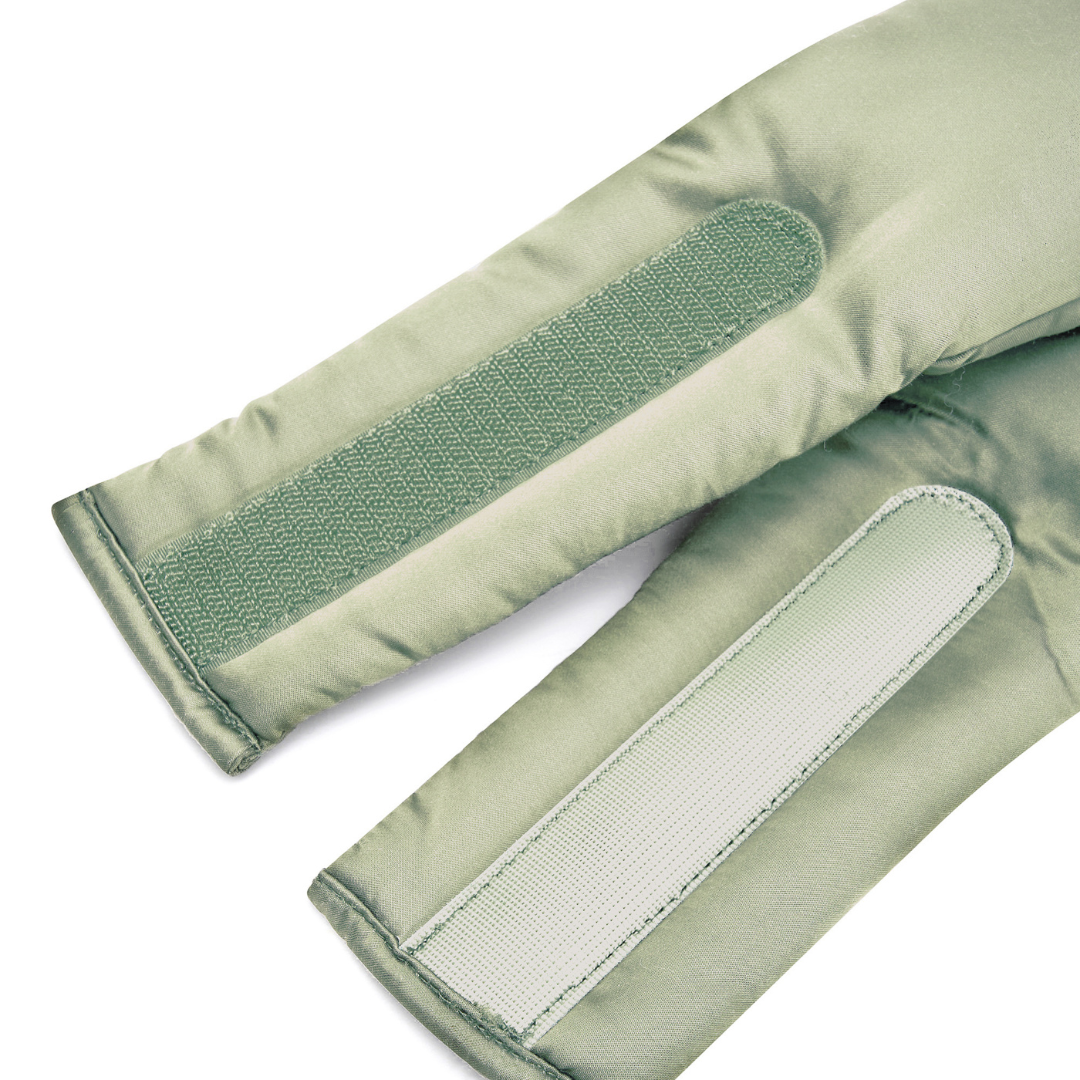 Close-up of two light green fabric straps with hook-and-loop fasteners, sewn onto padded material for the Sleep Mask - designed to block light, laying parallel on a white background.