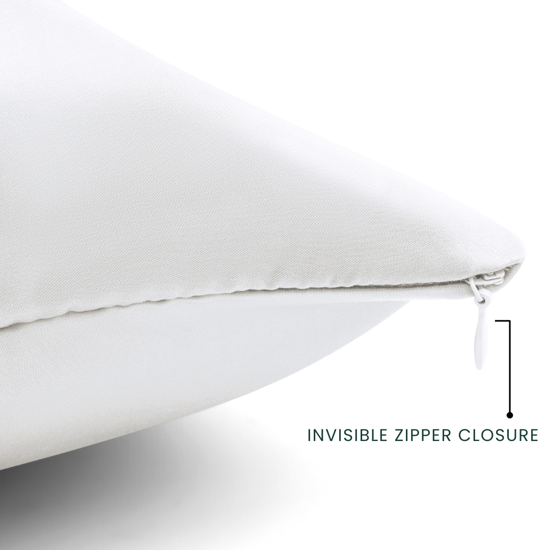 Close-up of a white pillow with an invisible zipper closure on a light gray background.