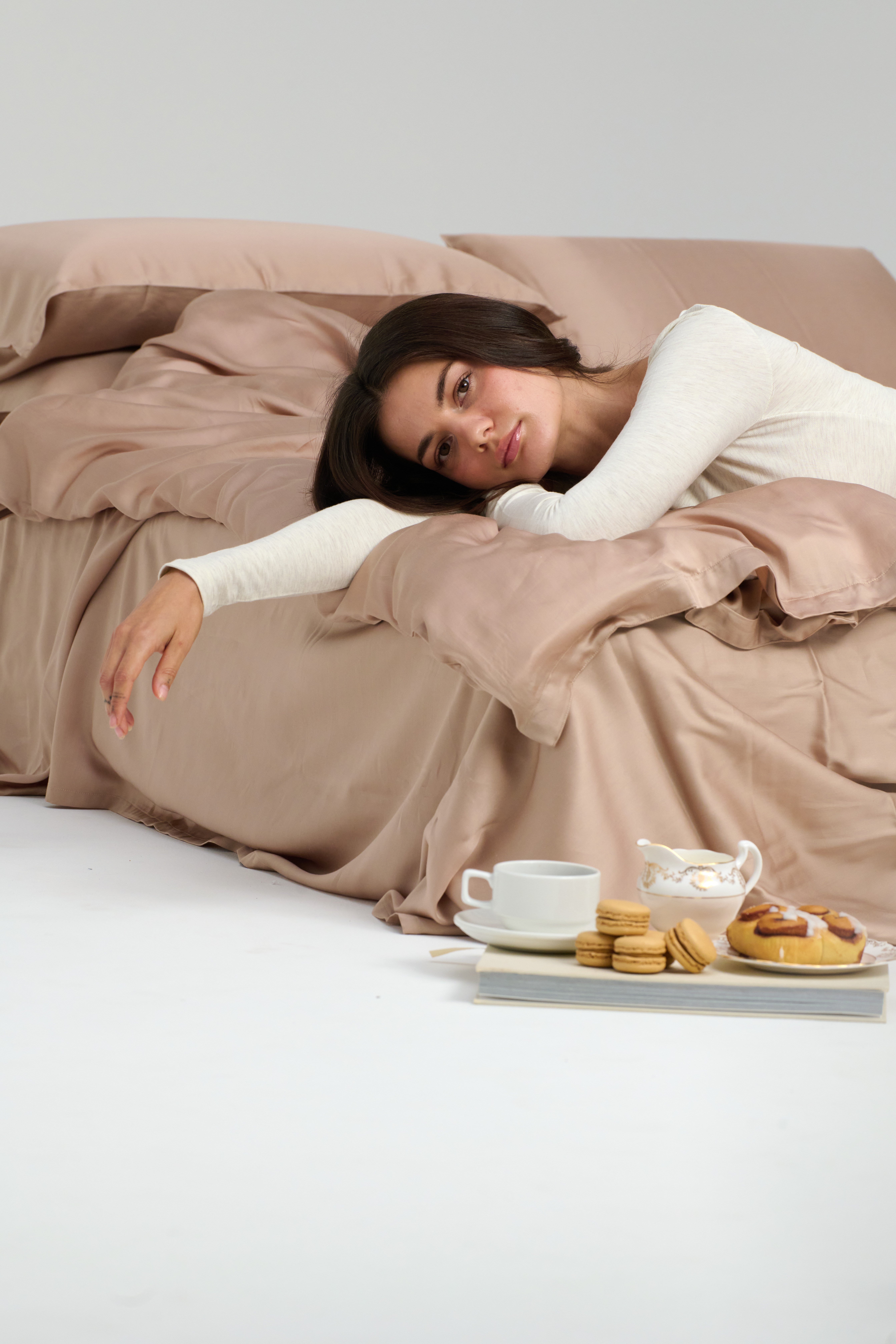 Woman resting on Mynt Lab bedding in forest setting